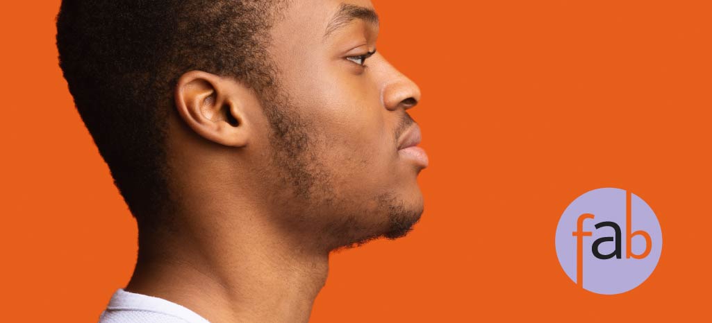 African American gentleman showing his chin from side view.